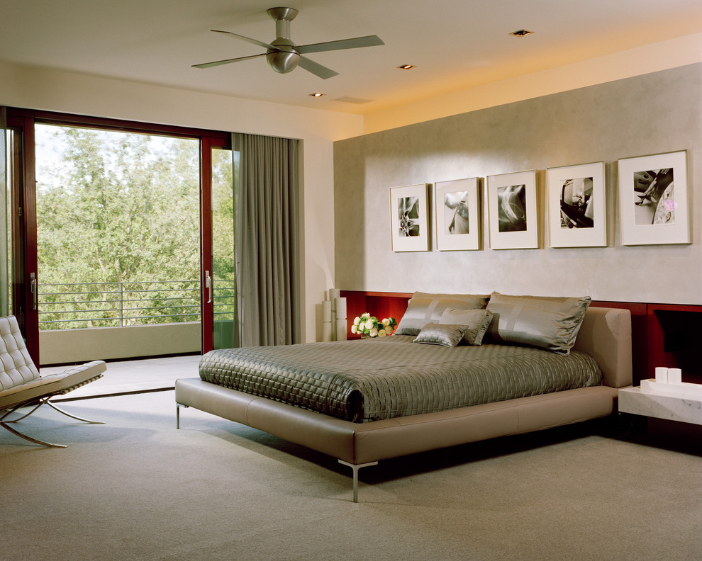 Photo of a large modern master bedroom in San Francisco with beige walls and carpet.