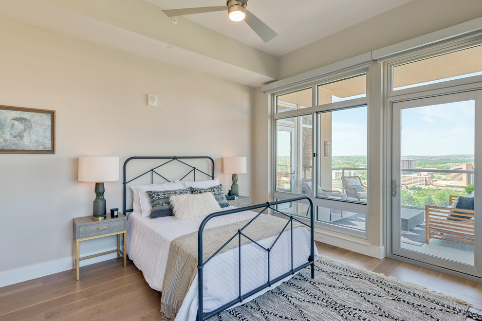 Bedroom - small transitional guest light wood floor and beige floor bedroom idea in Austin with beige walls