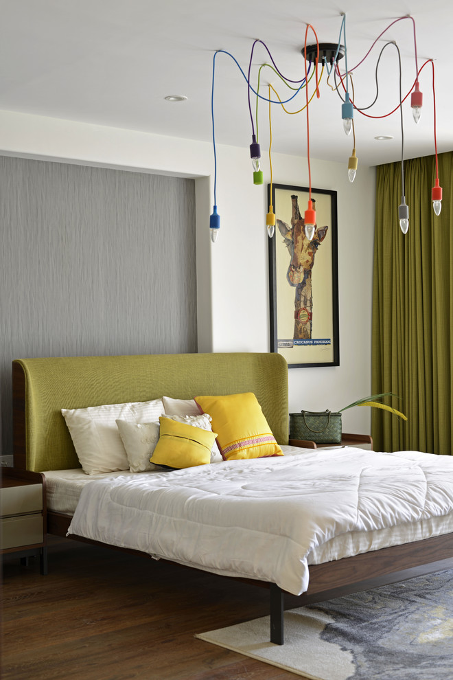 Inspiration for a contemporary bedroom in Mumbai with grey walls and dark hardwood flooring.