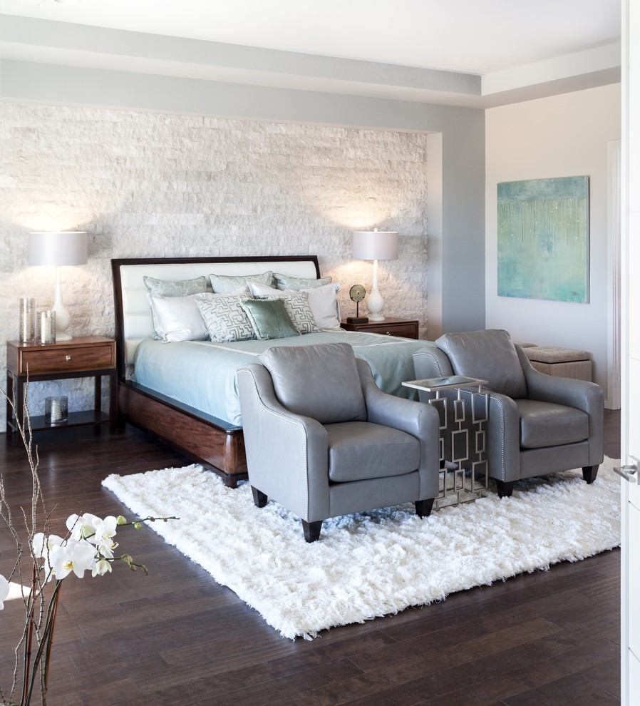 Large minimalist master medium tone wood floor bedroom photo in Sacramento with gray walls