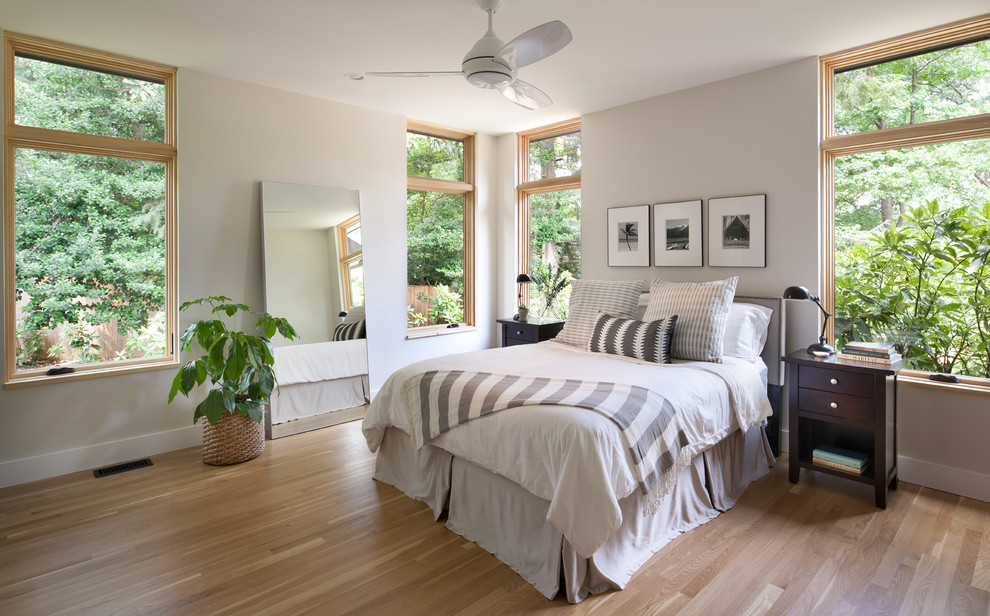 Mid-sized transitional master medium tone wood floor bedroom photo in DC Metro with beige walls and no fireplace
