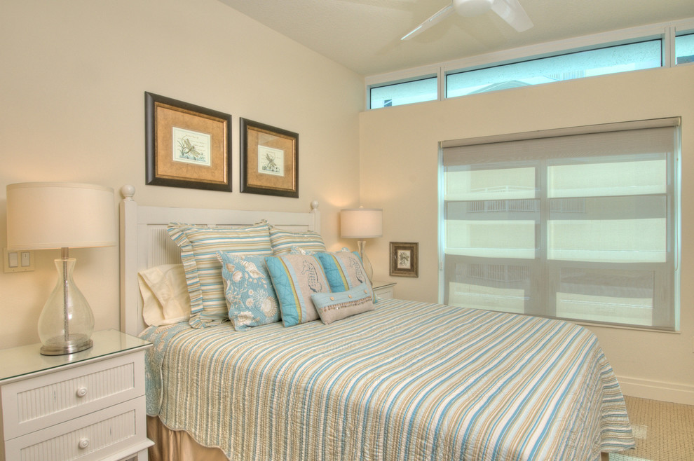 Example of a mid-sized island style guest carpeted bedroom design in Tampa with beige walls