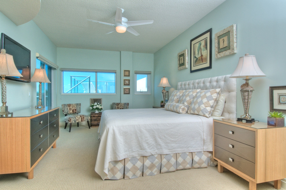 Ejemplo de habitación de invitados tropical de tamaño medio con paredes azules y moqueta