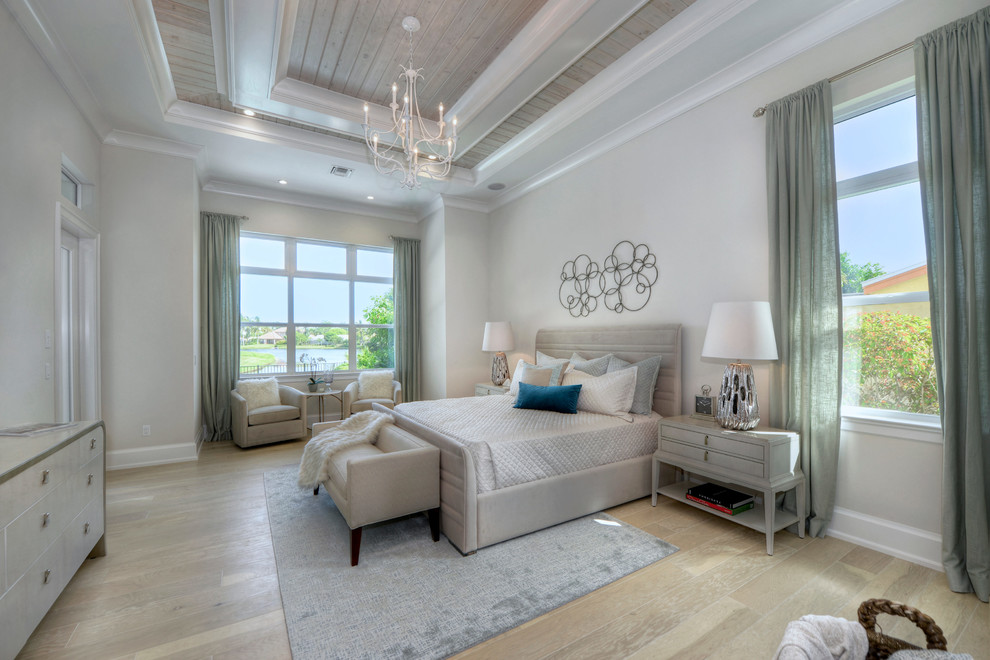 Inspiration for a transitional medium tone wood floor and brown floor bedroom remodel in Miami with gray walls