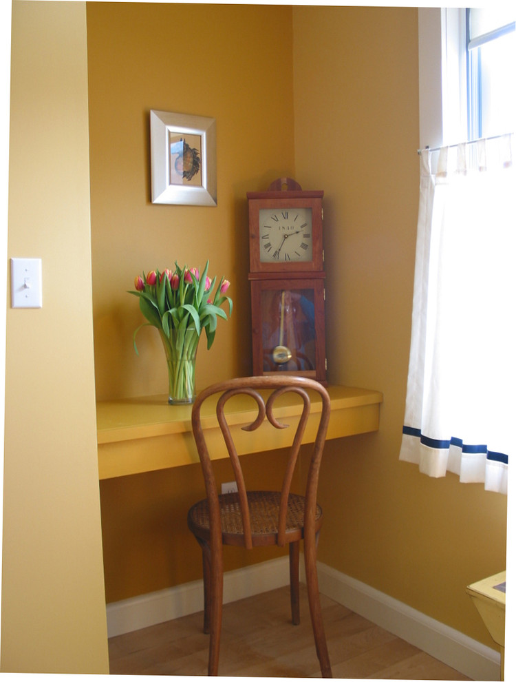 This is an example of a contemporary guest bedroom in Boston with yellow walls and light hardwood flooring.