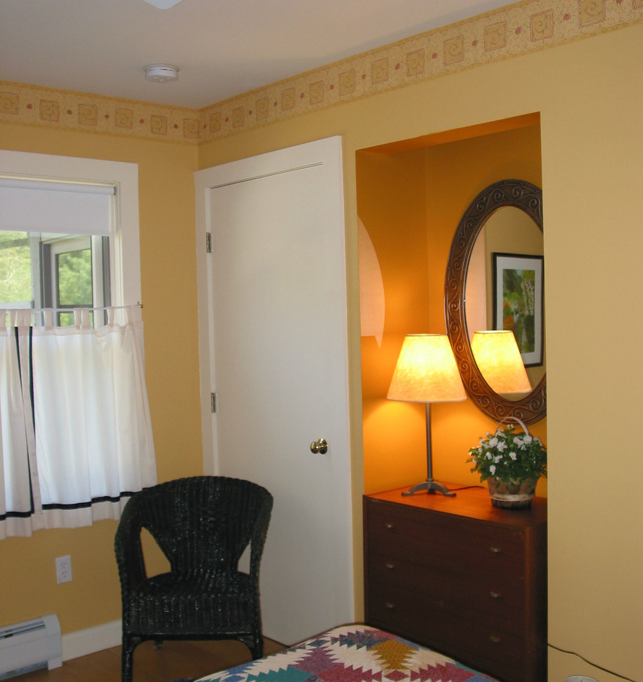 Mid-sized trendy guest light wood floor bedroom photo in Boston with yellow walls