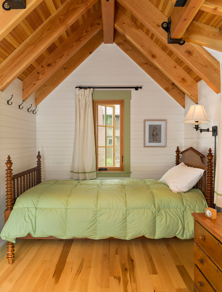 Bedroom - small rustic guest medium tone wood floor bedroom idea in Boston with white walls