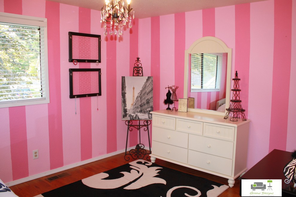 Design ideas for a medium sized classic bedroom in Seattle with pink walls and medium hardwood flooring.