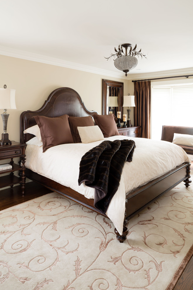 Photo of a large classic master bedroom in Toronto with beige walls and medium hardwood flooring.