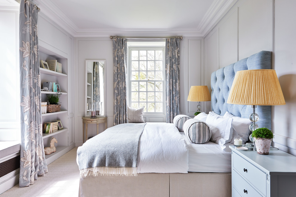 Medium sized classic guest bedroom with grey walls, carpet and beige floors.