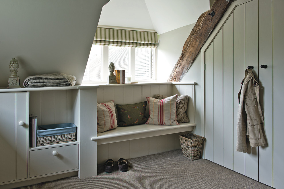 Large farmhouse bedroom in Gloucestershire with beige walls and carpet.