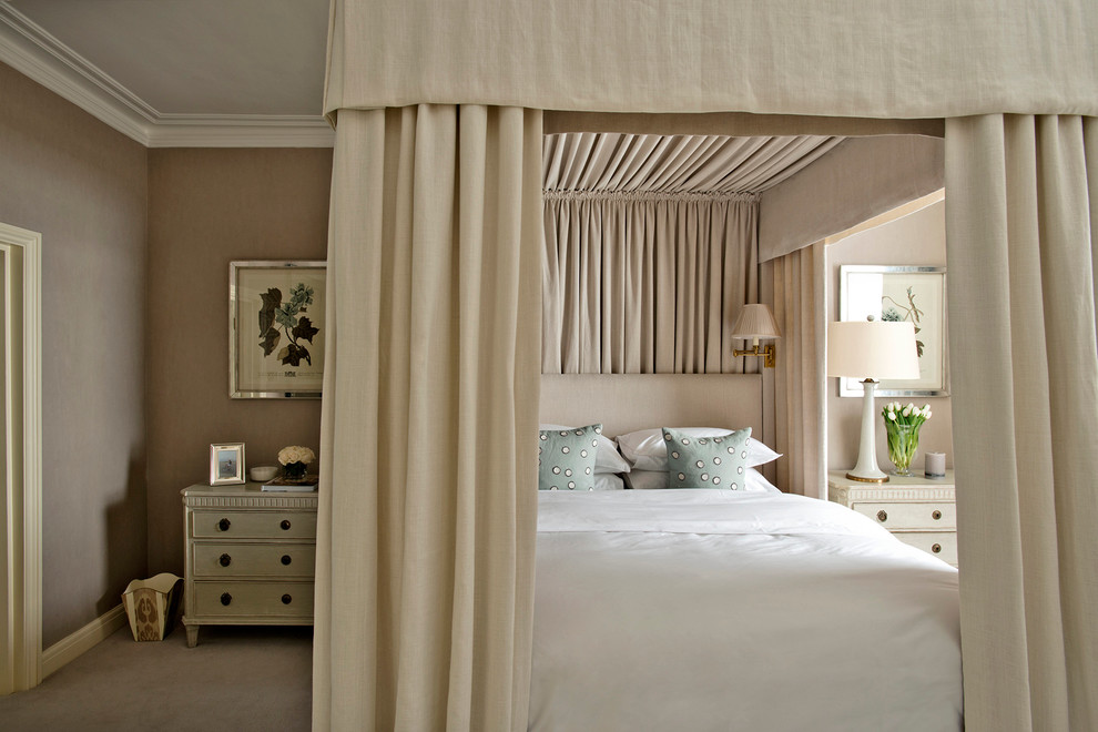 Photo of a traditional bedroom in London with beige walls and carpet.
