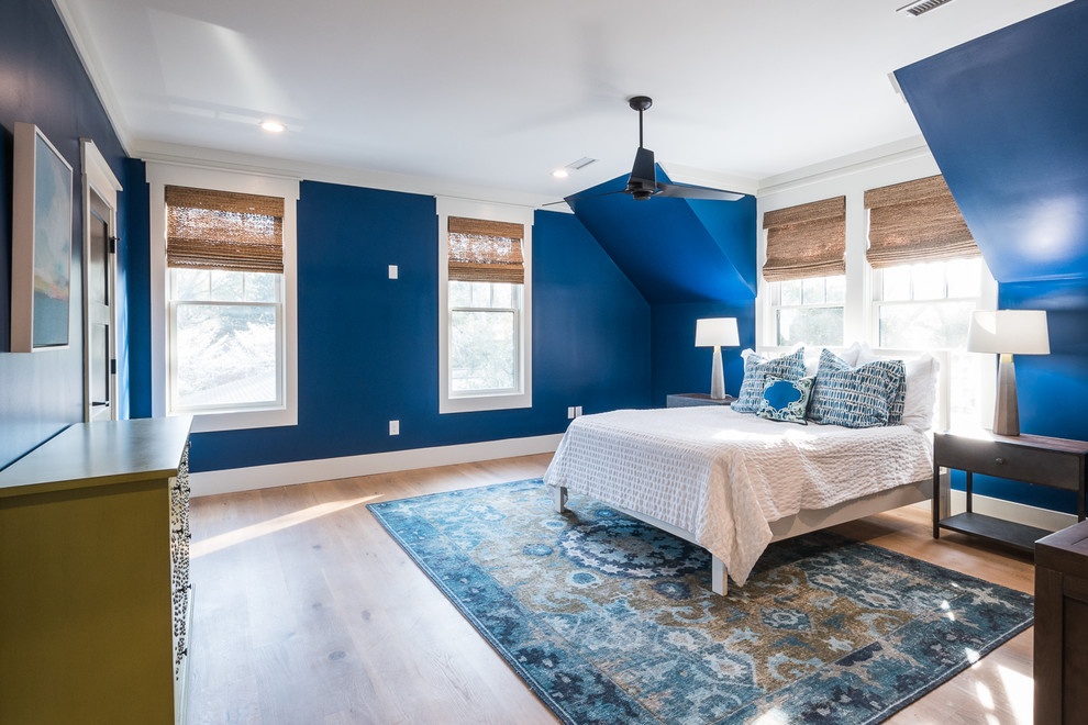 Diseño de habitación de invitados minimalista de tamaño medio con paredes azules, suelo de madera clara y suelo marrón