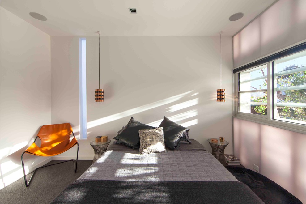 Medium sized contemporary master bedroom in Melbourne with white walls, carpet, a hanging fireplace and grey floors.