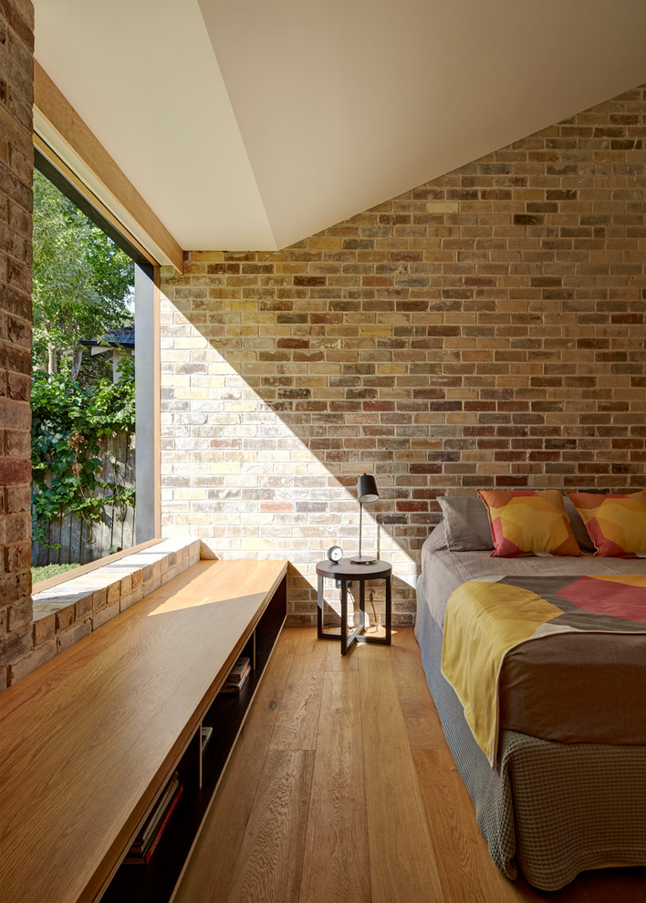 Design ideas for a medium sized contemporary master bedroom in Sydney with light hardwood flooring.