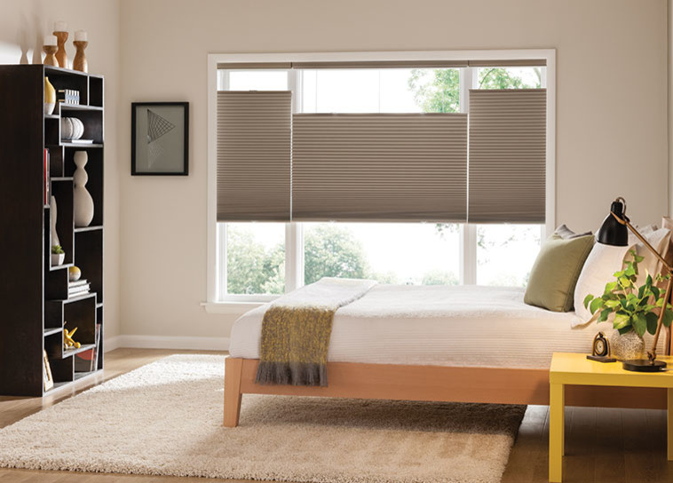 Bedroom - small traditional guest light wood floor bedroom idea in Orange County with beige walls