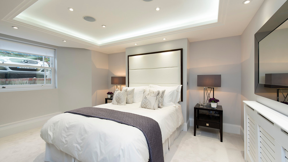 Design ideas for a large contemporary master bedroom in London with grey walls and carpet.
