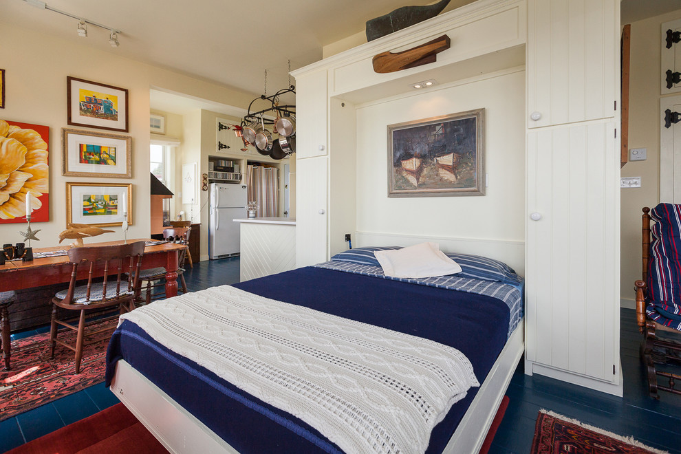Example of a beach style painted wood floor and blue floor bedroom design in Other