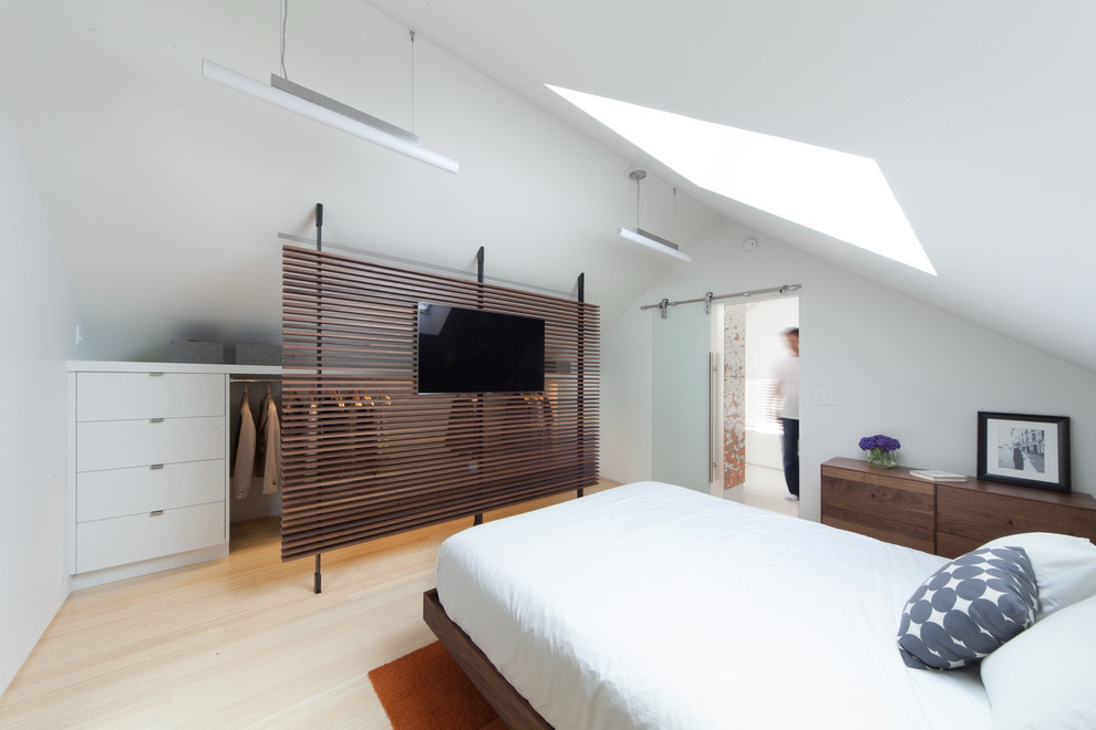 Example of a trendy light wood floor bedroom design in Seattle with white walls
