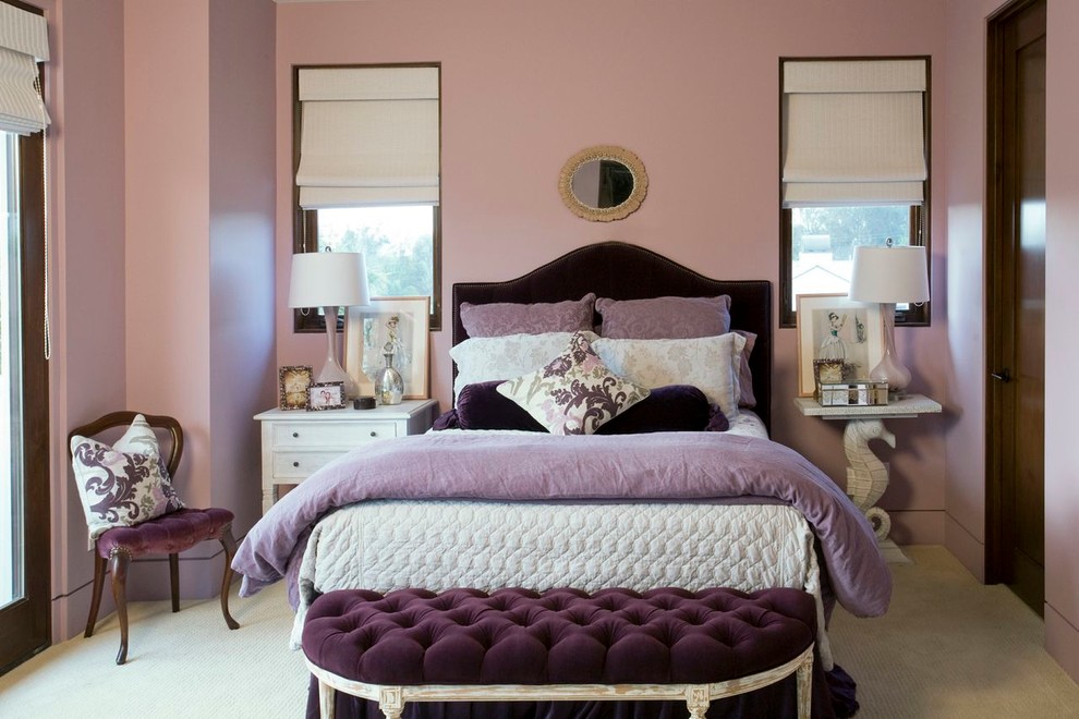 Traditional bedroom in Los Angeles with pink walls and carpet.