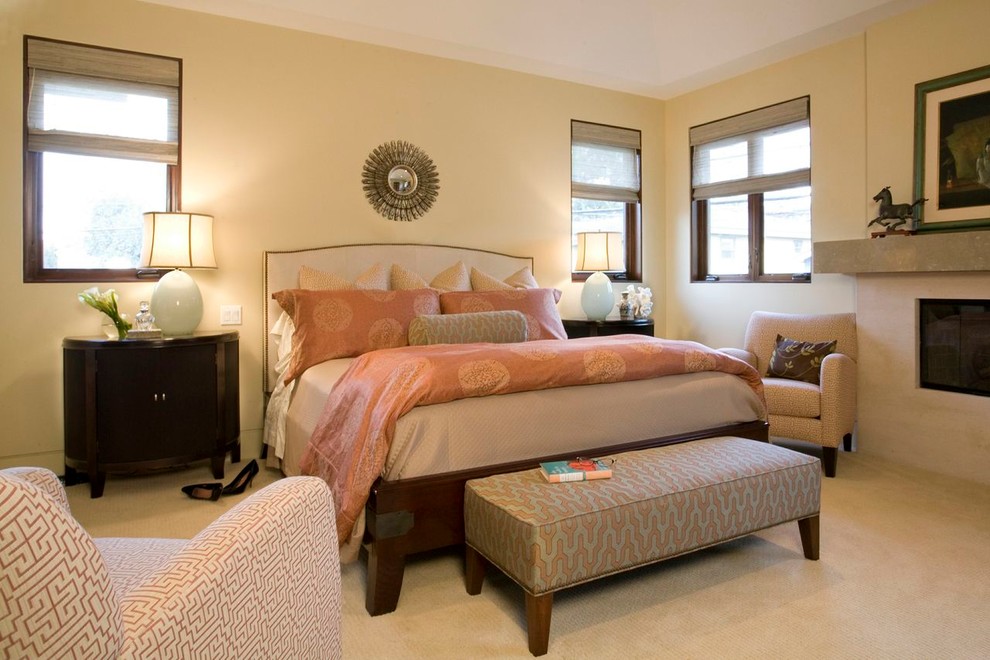 Inspiration for a classic master bedroom in Los Angeles with beige walls, carpet and a standard fireplace.
