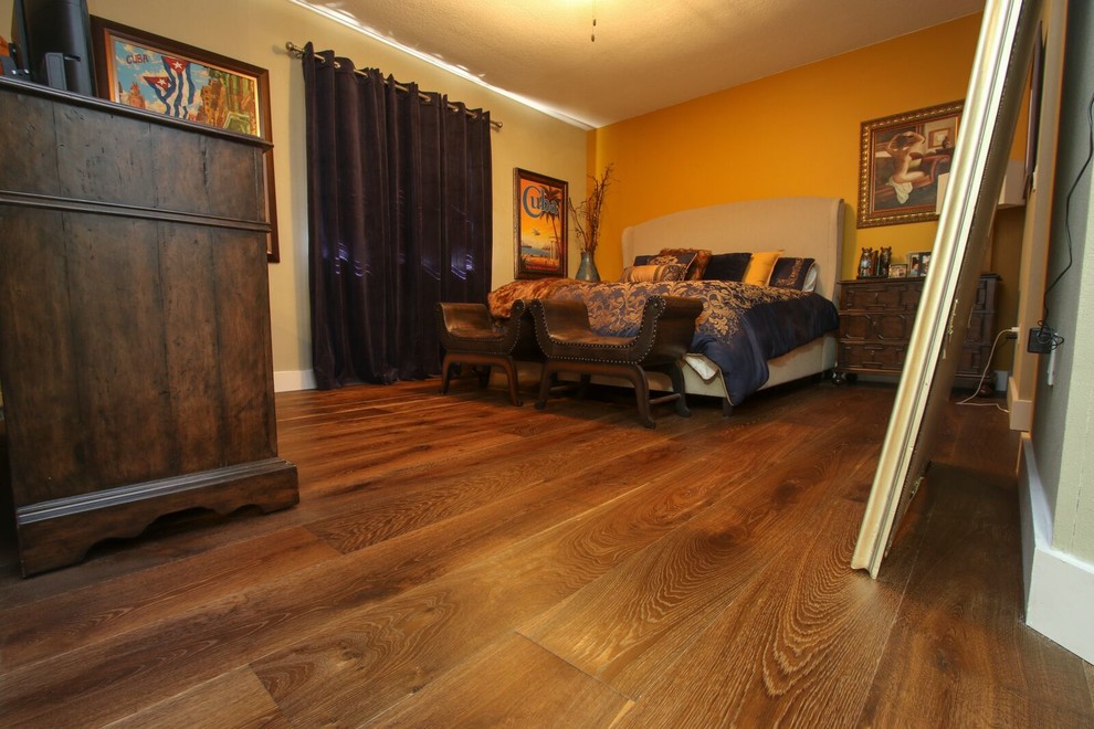 Example of a large transitional guest dark wood floor bedroom design in Miami with yellow walls and no fireplace
