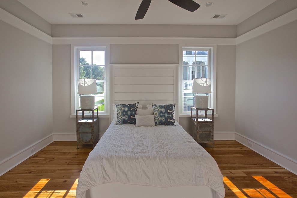 Design ideas for a nautical master bedroom in Charleston with grey walls, medium hardwood flooring and no fireplace.