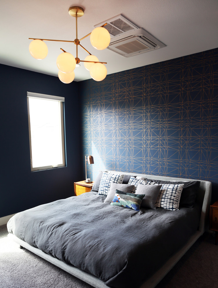Inspiration for a small midcentury master bedroom in Austin with blue walls, carpet, no fireplace and grey floors.