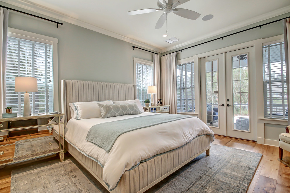 Inspiration for a large coastal master medium tone wood floor and brown floor bedroom remodel in Jacksonville with blue walls and no fireplace
