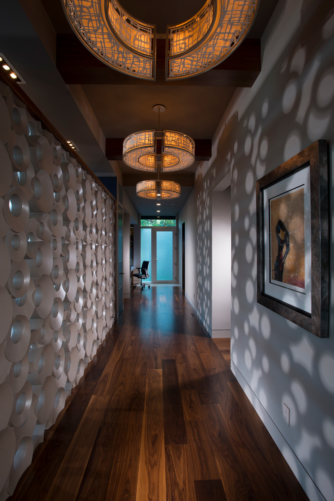 Example of a large trendy medium tone wood floor hallway design in San Francisco with multicolored walls