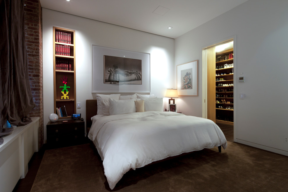 Inspiration for a large contemporary master bedroom in New York with white walls, carpet, no fireplace and brown floors.