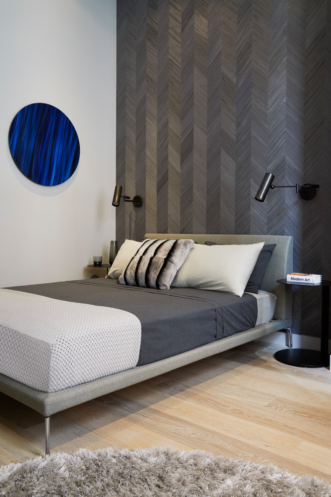 Bedroom - small contemporary master light wood floor and beige floor bedroom idea in New York with gray walls