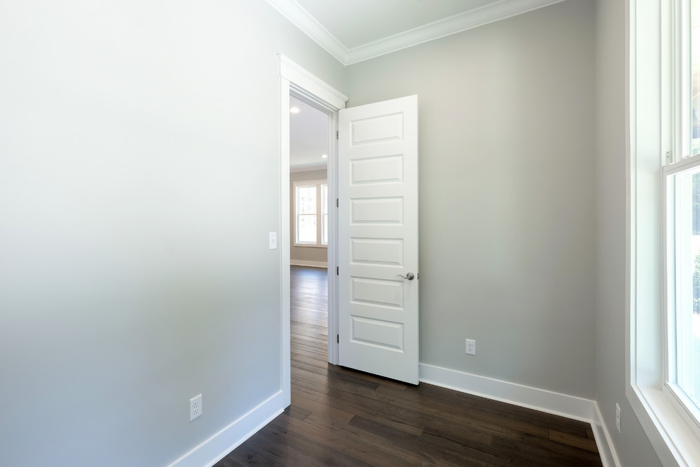 Mid-sized arts and crafts master medium tone wood floor and brown floor bedroom photo in New Orleans with gray walls