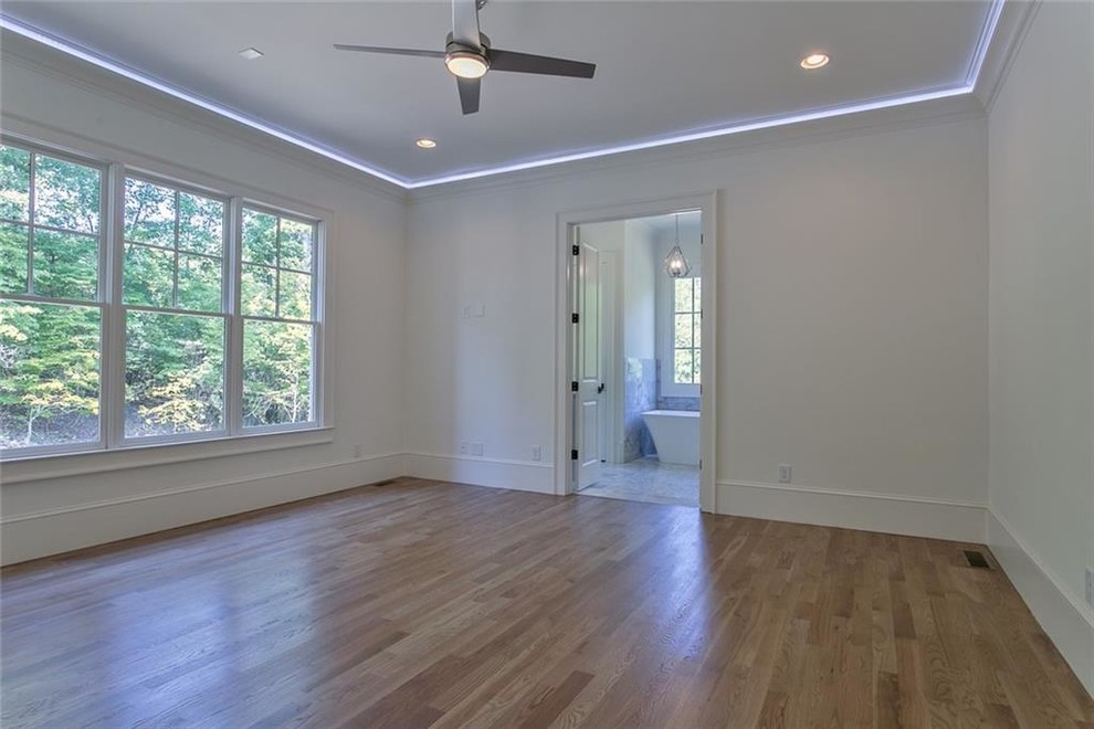 Bedroom - mid-sized master light wood floor and gray floor bedroom idea in Atlanta with white walls