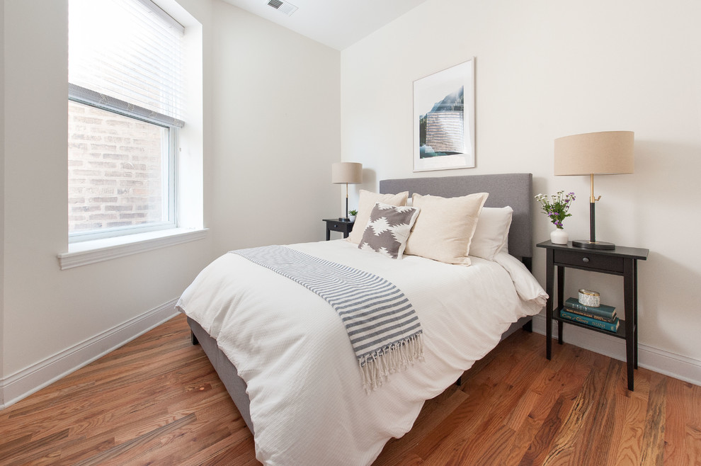 Design ideas for a small scandi guest bedroom in Phoenix with white walls and medium hardwood flooring.