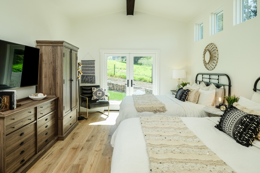 Design ideas for a rural bedroom in San Francisco with white walls, light hardwood flooring and beige floors.