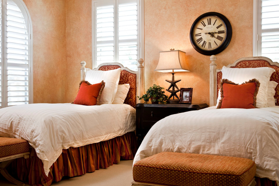 Inspiration for a mid-sized mediterranean guest carpeted bedroom remodel in Tampa with orange walls and no fireplace