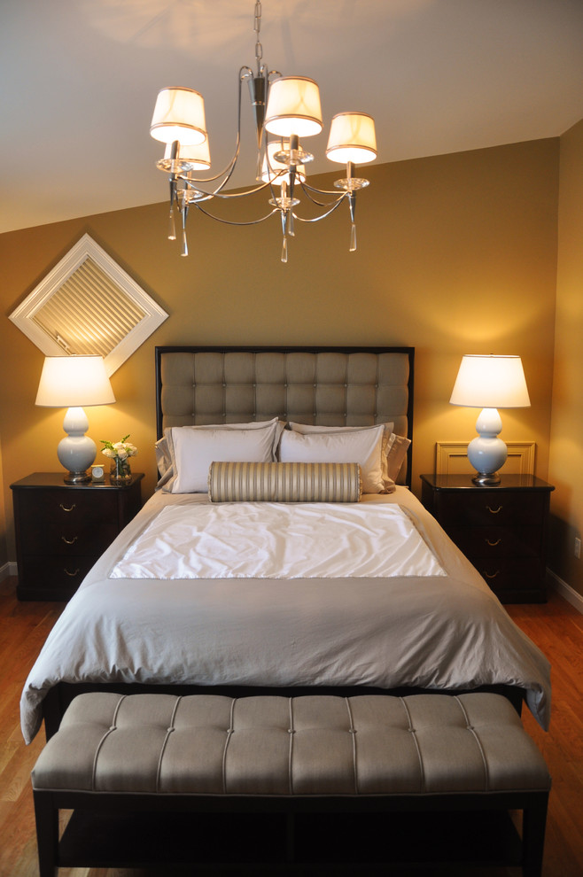 Design ideas for a medium sized traditional master bedroom in Burlington with beige walls and medium hardwood flooring.