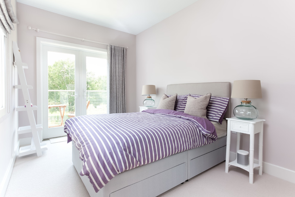 Inspiration for a large contemporary guest carpeted and gray floor bedroom remodel in Gloucestershire with pink walls and no fireplace