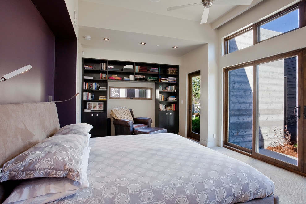 This is an example of a contemporary master bedroom in San Francisco with purple walls and carpet.