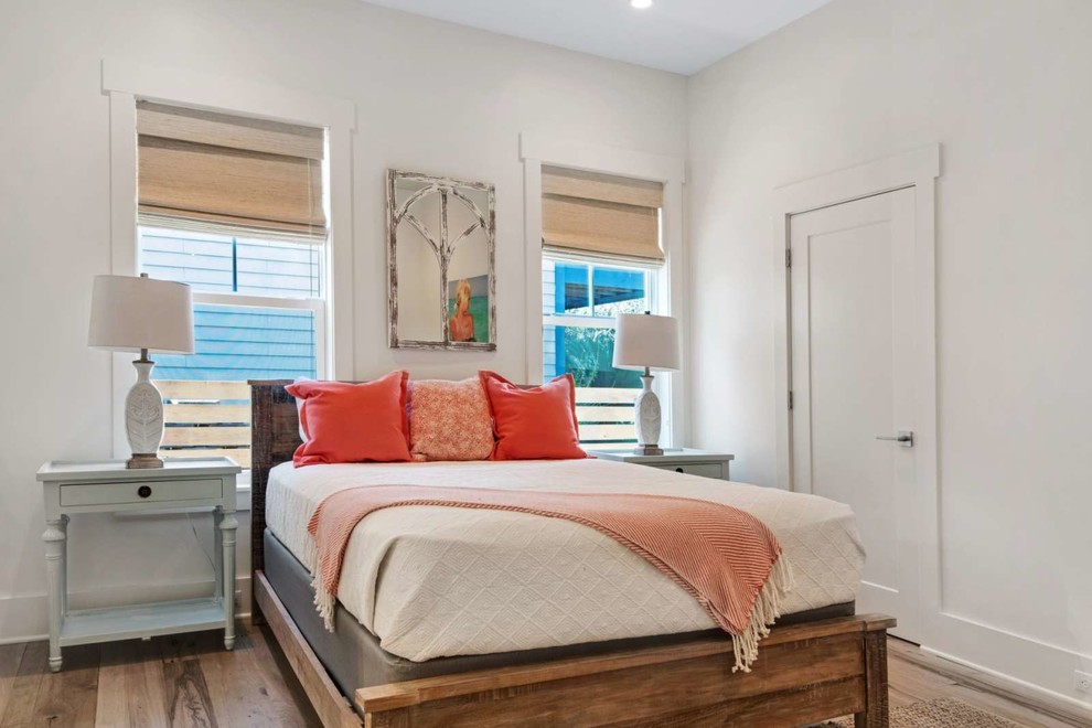 Mid-sized beach style guest dark wood floor and brown floor bedroom photo in Miami with white walls and no fireplace