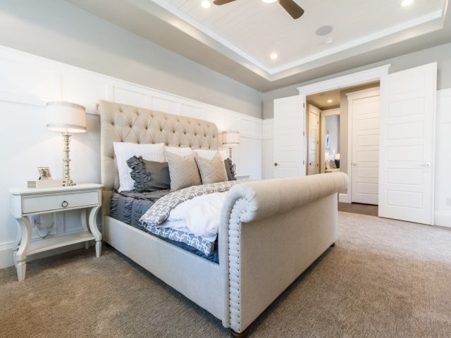 This is an example of a medium sized traditional master bedroom in Salt Lake City with grey walls, carpet and no fireplace.
