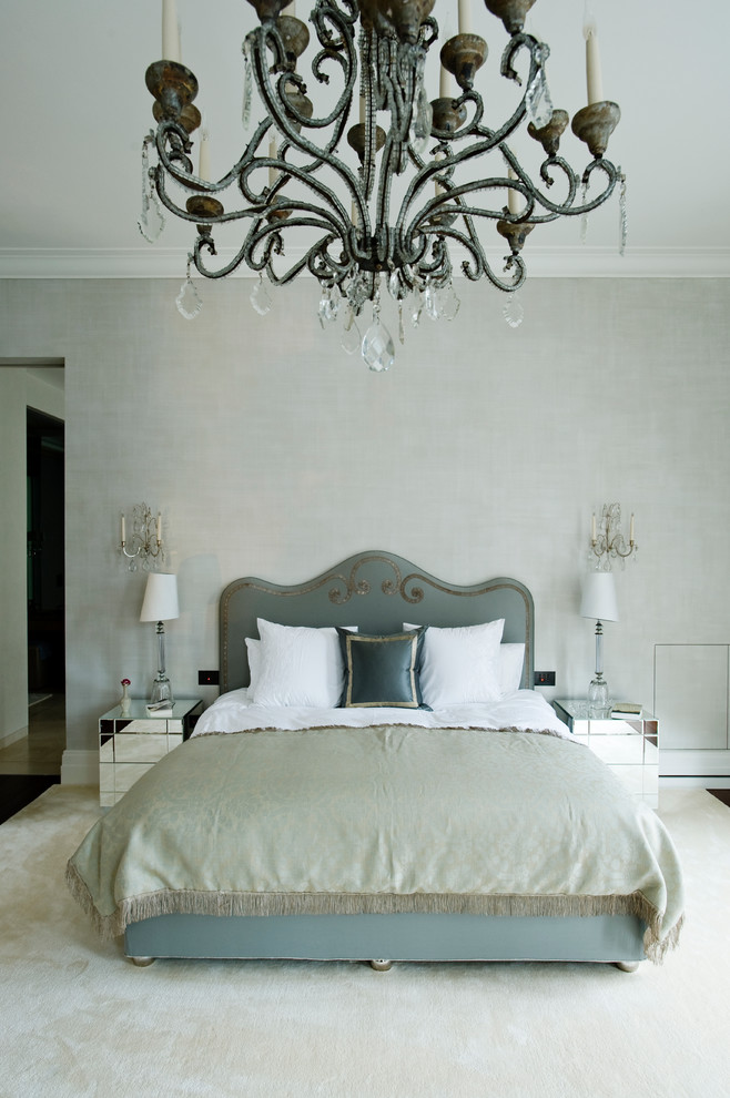 This is an example of a contemporary master bedroom in London with grey walls.