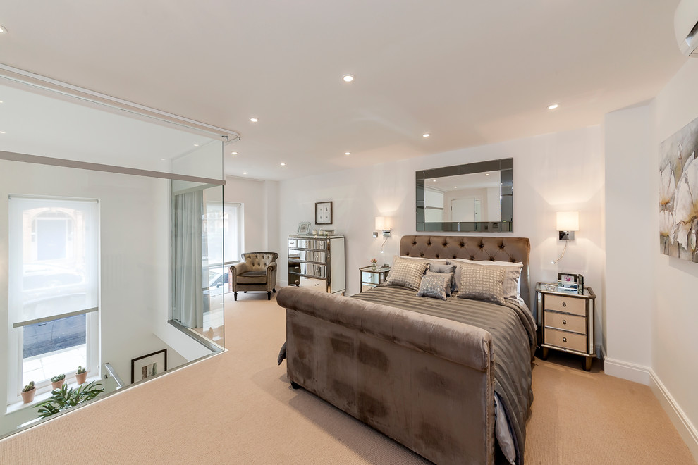 Medium sized classic bedroom in London with white walls, carpet and beige floors.