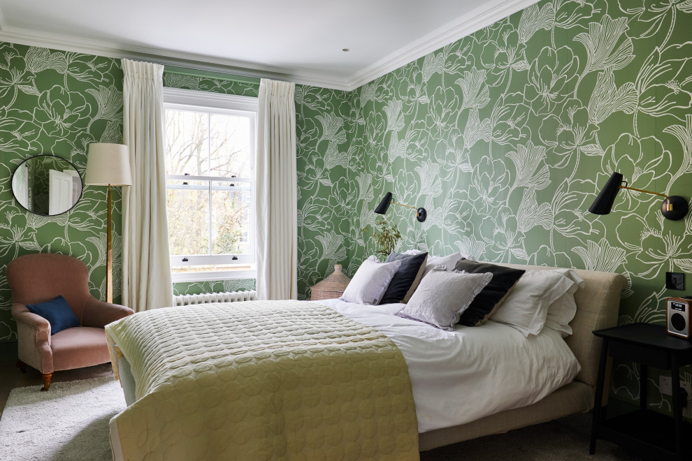 Inspiration for a traditional master bedroom in London with green walls, medium hardwood flooring, brown floors and wallpapered walls.