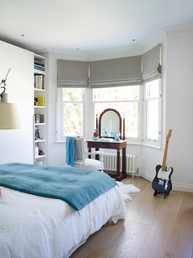 Photo of a contemporary master bedroom with grey walls.