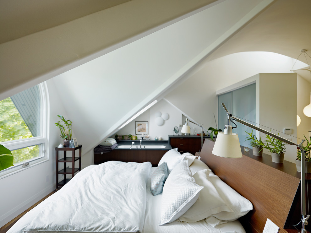 Diseño de dormitorio tipo loft contemporáneo grande con paredes blancas y suelo de madera en tonos medios