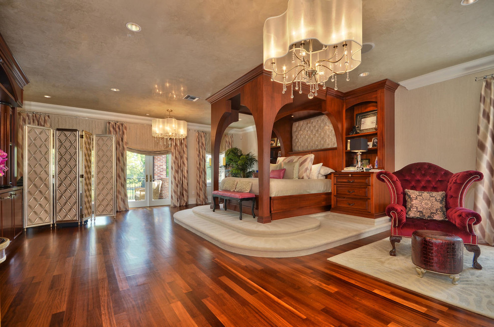 Example of a large transitional master medium tone wood floor bedroom design in Tampa with beige walls and no fireplace