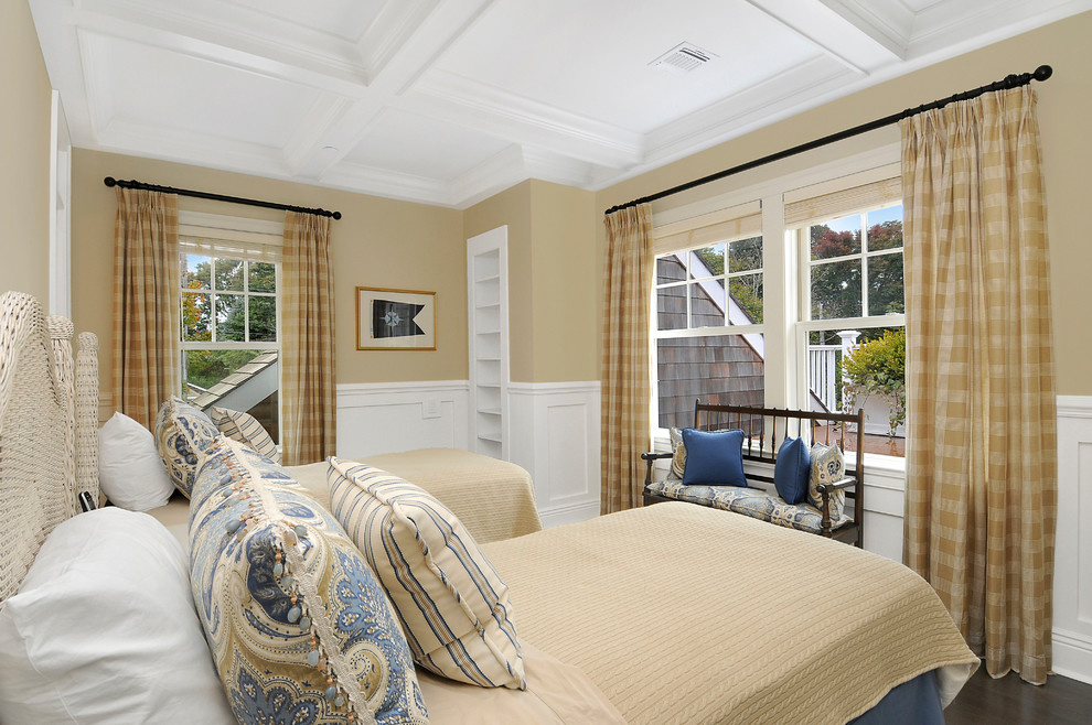 Classic guest bedroom in New York with beige walls, dark hardwood flooring and brown floors.