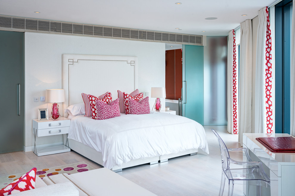 This is an example of a contemporary bedroom in London with white walls and grey floors.